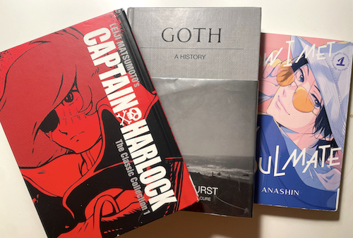 Three books on a desk